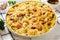 Macaroni bake with shrimps, mussels, fish, leek