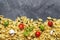 Macaroni, cherry tomatoes, , spices, oil, basil on a wooden background. top view.