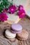 Macarons background red flowers and books, on a wooden table. Vertical frame. Aesthetics with macaroons and flowers. Beautiful