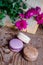 Macarons background red flowers and books, on a wooden table. Vertical frame. Aesthetics with macaroons and flowers. Beautiful