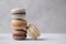 Macarons chocolate, caramel and vanilla on light background