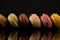 Macarons, Colorful Horizontal Stack of Macarons, isolated on black background with reflections
