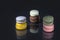 Macarons concept in complementary colors on black background with reflection