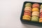 Macarons gift box cute assortment of yummy pastel colored macaron different flavours - pistachio, lemon, raspberry