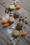 Macarons multicolored lie on a wooden table with various ingredients, chocolate, coffee, tangerines and more.