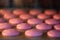 Macarons in the oven. Cooking at home. Sweet and colourful pink french macaroons