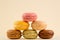 Macarons Pile, Beautiful multiple Colored Stack of Macarons, isolated on yellow background