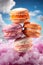 macaroon stacked on top of each other with cotton candy pink clouds and clouds background