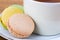 Macaroon and Teacup on wood, Closeup