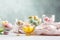 Macaroons in glass elegant bowl on table with textile linen tablecloth on neutral background