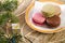 Macaroons stacked on plate, wooden background