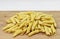 Maccheroni al pettine on wooden background. Raw italian pasta