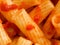 Maccheroni pasta in tomato sauce food background