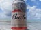 MACEIO, AL, BRAZIL - May 12, 2019: Budweiser cold beer and a beautiful sky and sea behind