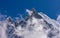 Machapuchare snowcapped mountain summit rises among the clouds, Nepal