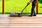 Machine cleaning of a wooden terrace - dry method - grinding the boards with handy sanding machine