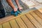 Machine cleaning of a wooden terrace - dry method - grinding the boards with handy sanding machine