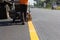 Machine eject and worker on road and traffic sign painting