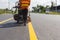 Machine eject and worker on road and traffic sign painting