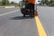 Machine eject and worker on road and traffic sign painting