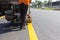 Machine eject and worker on road and traffic sign painting