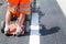 Machine eject and worker on road and traffic sign painting