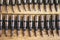 Machine gun ammo on a wooden table, bullet belt, bandoleer, chain of ammo on wooden background,cartridge 7.62 mm caliber, top view