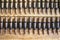 Machine gun ammo on a wooden table, bullet belt, bandoleer, chain of ammo on wooden background,cartridge 7.62 mm caliber, top view