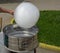 Machine for making sweet wool, production. Sweet white cotton wool on a stick in hand against a park background