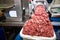 Machine mincing meat in grocery store