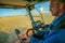 The machine operator at the helm of a modern combine harvester harvests grain