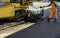 Machine operator to spread asphalt,