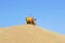 Machine is processing grain harvest in a blue sky, Australia