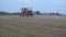 Machine spray farm field weeds with herbicides in autumn. Panorama. 4K