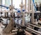 Machine tightens the lids on plastic bottles. Mineral water production line