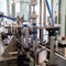 The machine tightens the lids on plastic bottles. Water production line