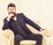 Macho attractive and elegant on serious face and thoughtful expression. Man with beard and mustache wearing classic suit