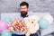 Macho ready romantic date. Man wear blue tuxedo bow tie hold flowers bouquet. Romantic man with flowers and teddy bear