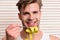 Macho with smiling face holds yellow measure tape on fork.