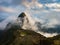 Machu Picchu illuminated by the first sunlight coming out from the opening clouds. The Inca`s city is the most visited travel des