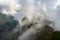 Machu Picchu illuminated by the first sunlight coming out from the opening clouds. The Inca`s city is the most visited travel des