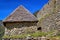 Machu Picchu, Peru - Inca Masonry Stone Walls and Temple House Building with Thatched Roof inside Machu Picchu