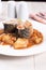 Mackerel pieces closeup with potato and tomato