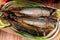 Mackerel smoked fish on wooden hardboard on wooden table