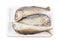 Mackerels steamed in a pack on white background