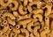 Macro background texture of wholemeal ribbed uncooked macaroni
