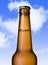 Macro beer golden bottle neck with frost and bubbles in brown glass on blue sky