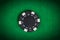 Macro black poker chip on green table