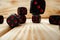 Macro of black tossed dice on wooden background