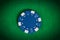 Macro blue poker chip on green table